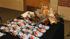 photo of a decorated table with snowman cookies and holly