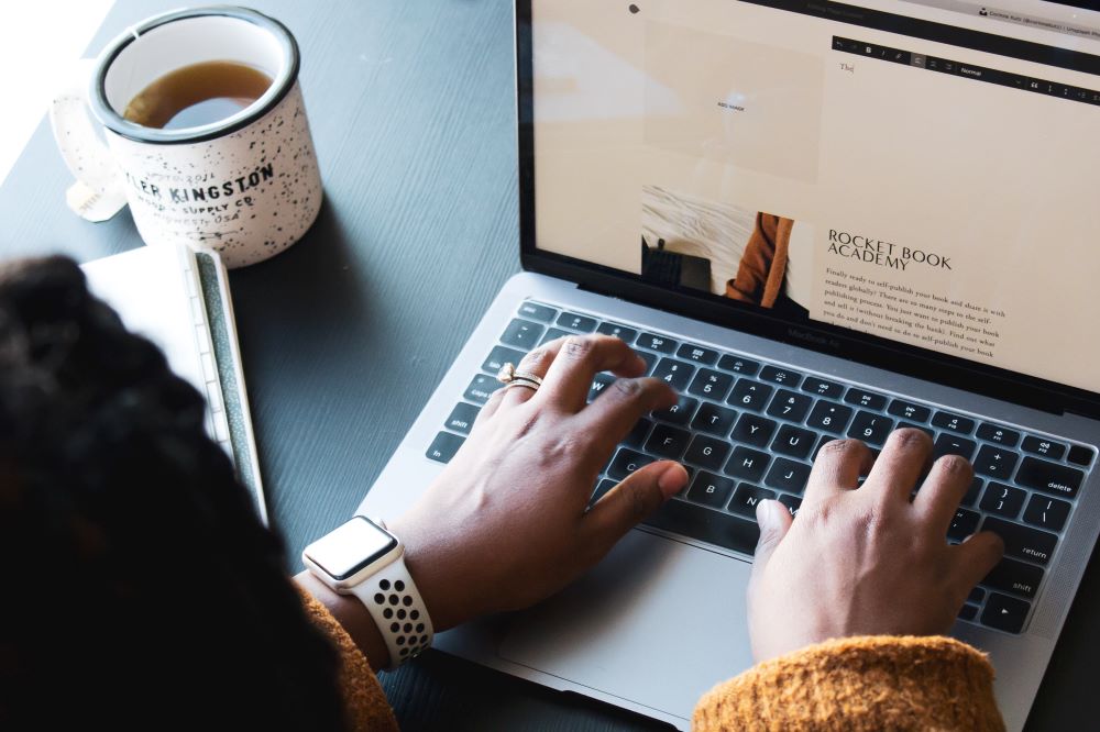 Person Typing on Laptop