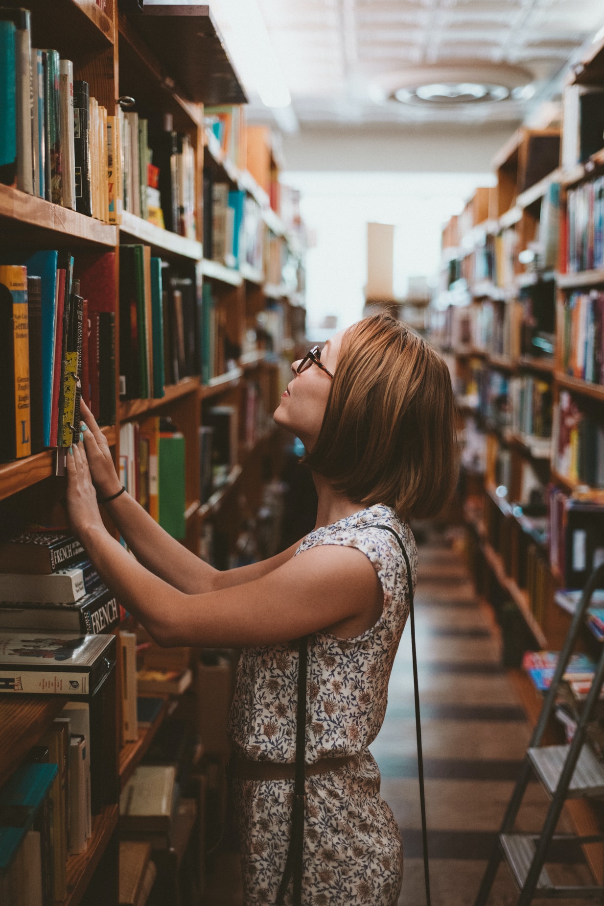 Woman looking through bookshelves