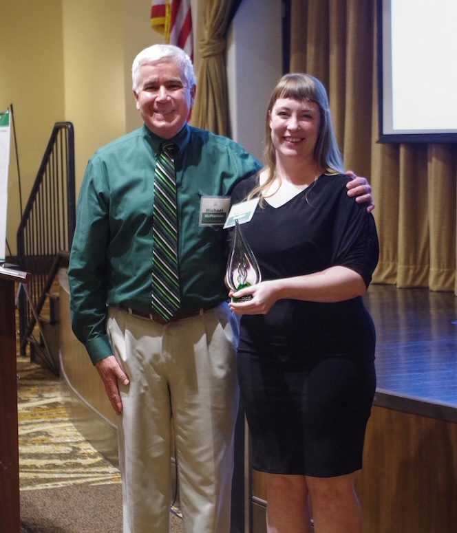 Annette Becker and Mike McPherson posing with OLLI at UNT award