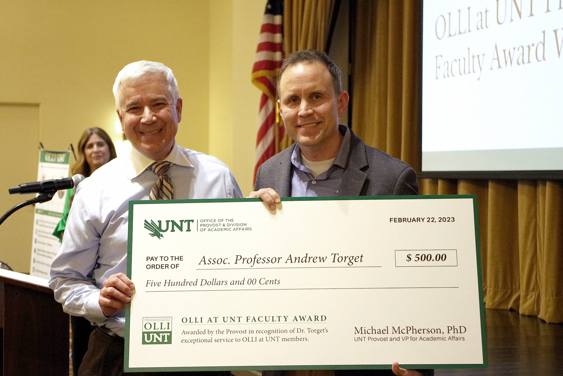 Provost McPherson and OLLI at UNT Faculty Award winner Andrew Torget pose with his giant check 