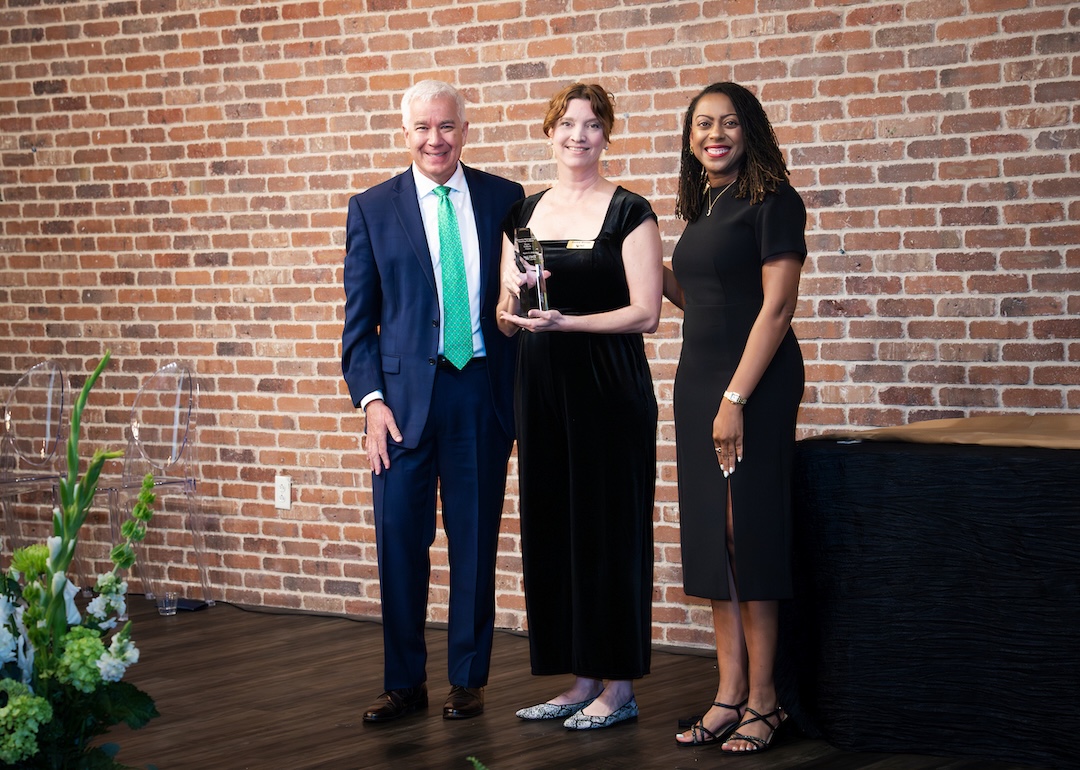 Nora Gilbert receiving award on stage