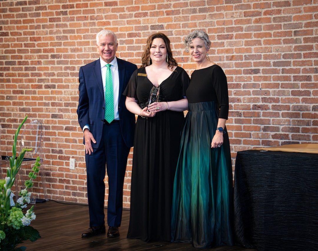 Mara Hedrich receiving award on stage