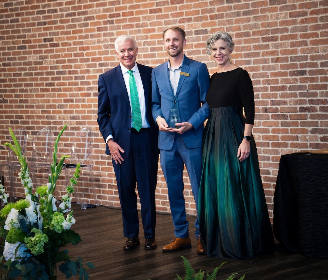 Brian Meckes receiving award on stage