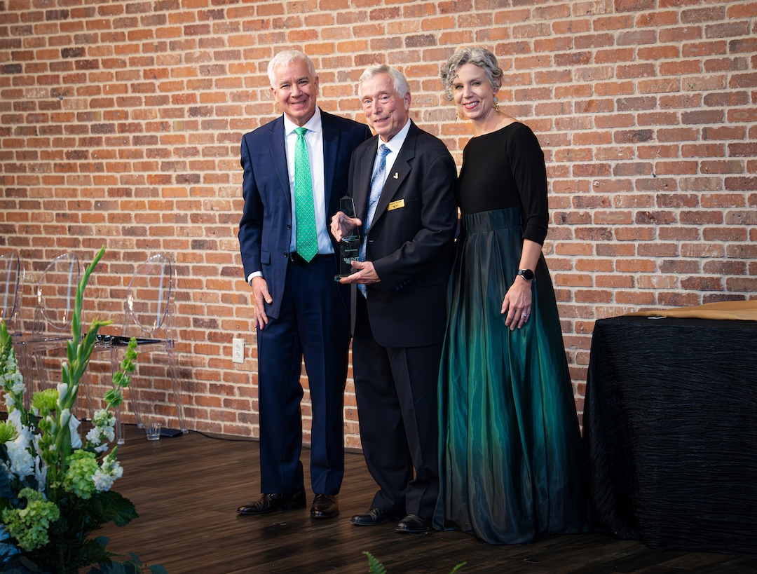 Terry Pohlen receiving award on stage