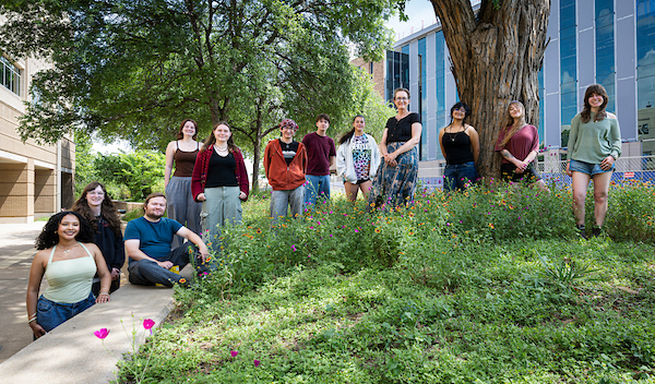 Jaime Baxter-Slye standing in a field of flowers with students