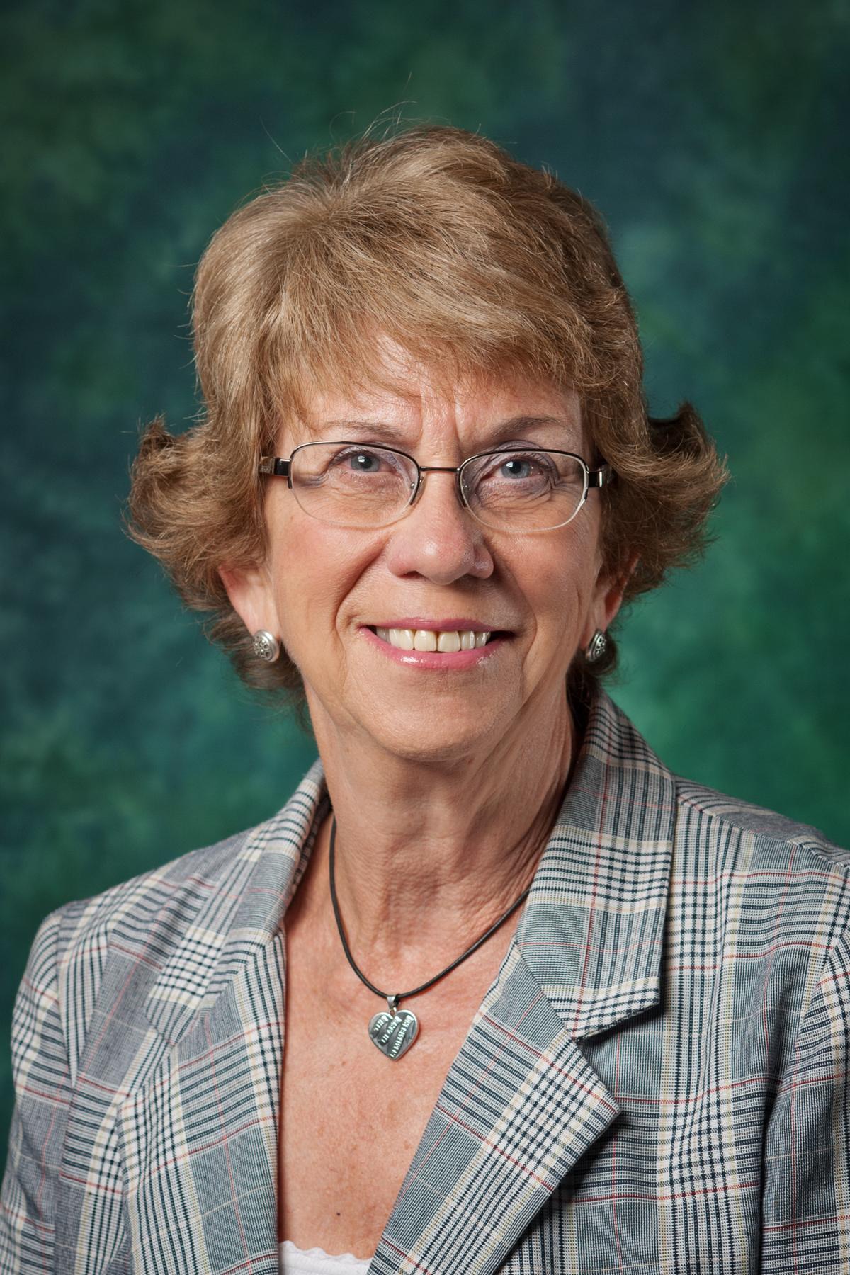 Carol Wickstrom in front of green background