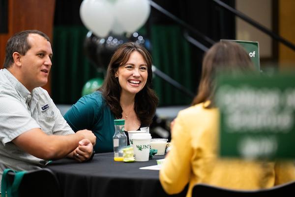 Faculty smiling and talking at their tables during Fall New Faculty Orientation