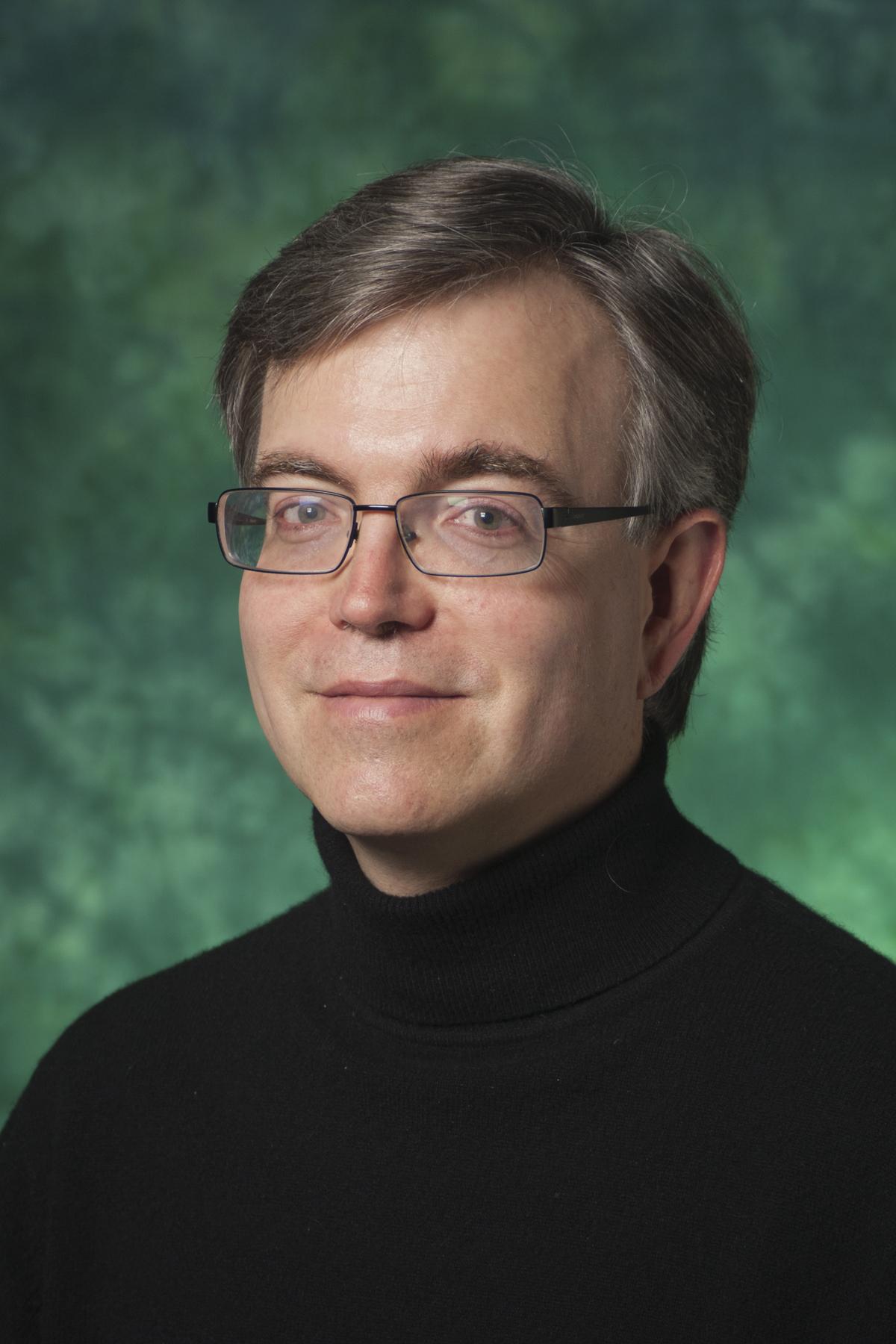 Eric Nestler in front of a green background