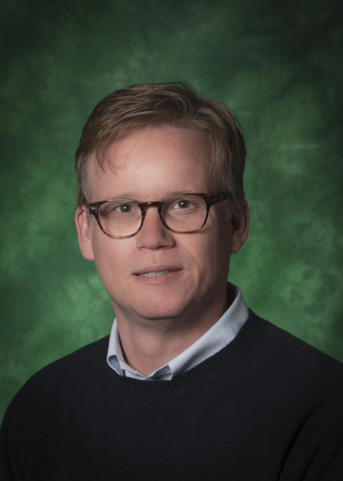 J. Todd Moye in front of a green background