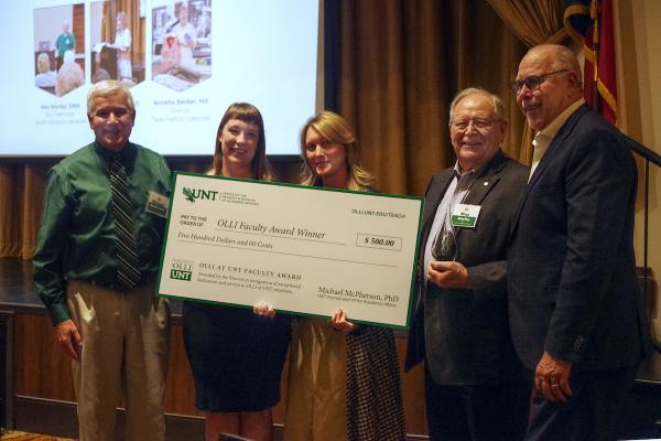 UNT president and provost pose with OLLI at UNT Faculty Award winners and giant check