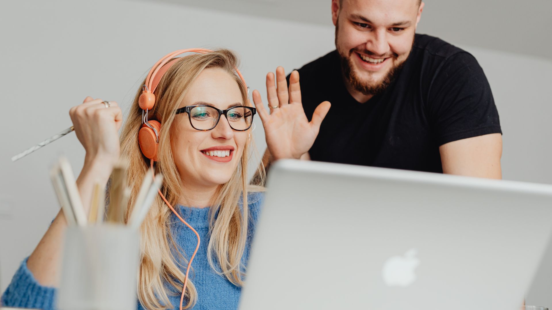 Two people looking at a laptop screen