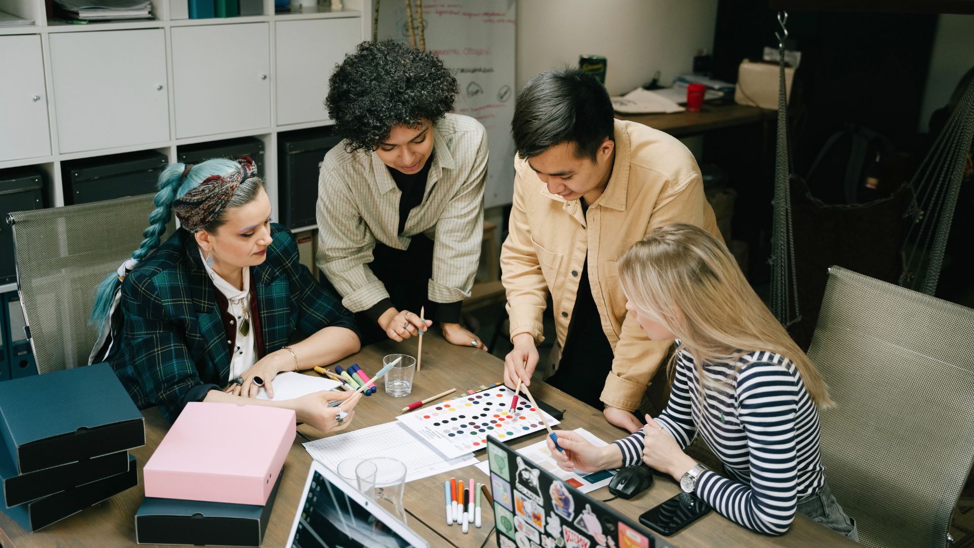 Four people looking at a graphic organizer